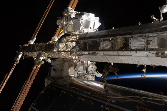 Can you find the astronauts in this image? Drew Feustel (top left) and Greg Chamitoff (center left), work during the first EVA of the STS-134 mission. Credit: NASA