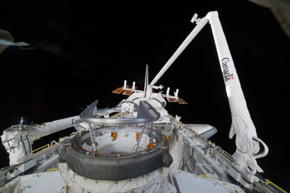 A careful look at this scene in Earth orbit reveals the International Space Station (ISS) at frame center, as the ISS and Endeavour (partially seen in foreground) prepare to dock. Photo credit: NASA