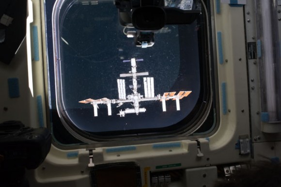 The ISS hovers in the aft flight deck window of space shuttle Endeavour during rendezvous and docking operations. Photo credit: NASA
