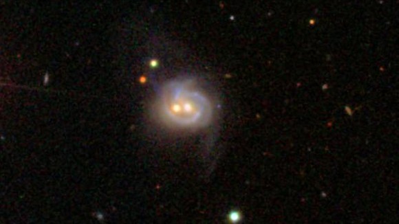 Viewed in visible light, Markarian 739 resembles a smiling face. Inside are two supermassive black holes, separated by about 11,000 light-years. The galaxy is 425 million light-years away from Earth. Credit: Sloan Digital Sky Survey