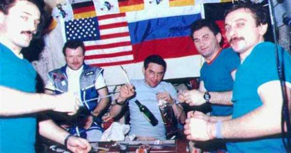 Cosmonauts gather to have some cognac on the Mir space station in 1997. The image was taken by NASA astronaut Jerry Linenger.