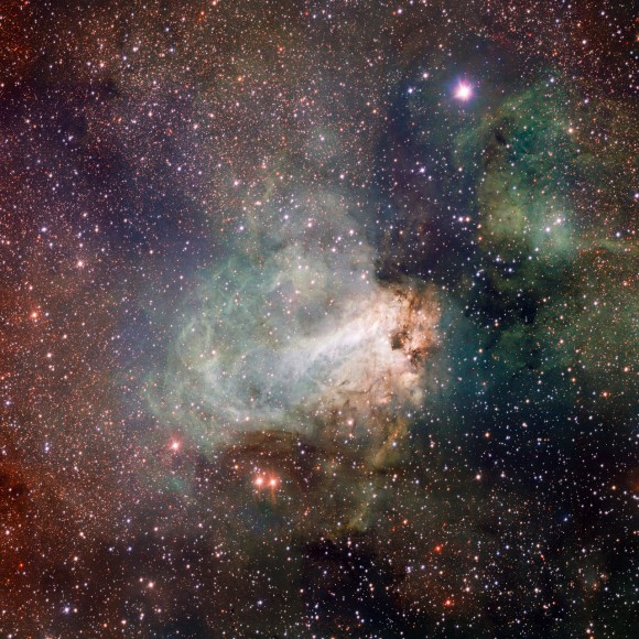 The first released VST image shows the spectacular star-forming region Messier 17, also known as the Omega Nebula or the Swan Nebula. Credit: ESO/INAF-VST/OmegaCAM. Acknowledgement: OmegaCen/Astro-WISE/Kapteyn Institute.