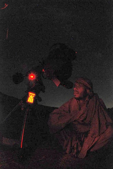 A local farmer from Afghanistan looks at the night sky through a telescope. Credit: Yunos Bakhshi from the Afghanistan Astronomy Association.