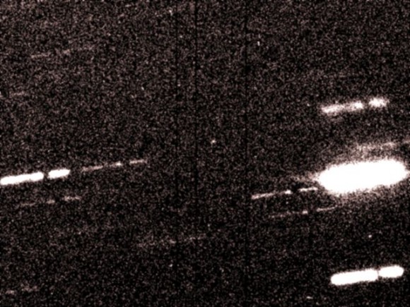 2010 TK7 is seen as a speck of light in the center of this image, which is the addition of three individual exposures taken with the MegaCam camera at CFHT. The telescope was tracking the motion of the asteroid, leading to the image of the stars to be trailed. With three exposures added, stars end up looking like a broken trail. Credit: C. Veillet, Canada-France-Hawaii Telescope.