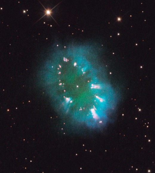 The Necklace Nebula is located 15,000 light-years away in the constellation Sagitta (the Arrow). In this composite image, taken on July 2, 2011, Hubble's Wide Field Camera 3 captured the glow of hydrogen (blue), oxygen (green), and nitrogen (red). Credit: NASA, ESA, and the Hubble Heritage Team (STScI/AURA)