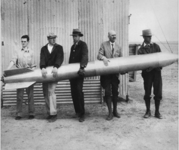 Dr. Robert H. Goddard (second from right) and his colleagues hold a liquid-propellant rocket in 1932 at their New Mexico workshop. Credit: NASA Goddard Space Flight Center.