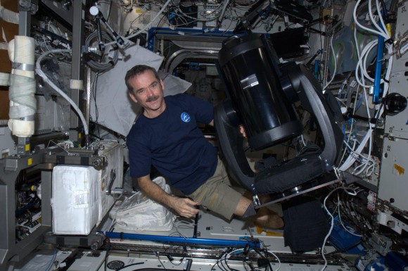 Canadian astronaut Chris Hadfield with the new ISERV (International Space Station SERVIR Environmental Research and Visualization System), a modified Celestron telescope for Earth observation. Credit: NASA/CSA