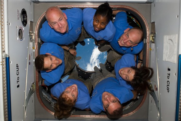 The STS-131 crew somehow organizes themselves on the small window in microgravity. Pictured are Commander Alan Poindexter, Pilot James P. Dutton Jr. and Mission Specialists Dorothy Metcalf-Lindenburger, Rick Mastracchio, Naoko Yamazaki, Clayton Anderson and Stephanie Wilson. Credit: NASA