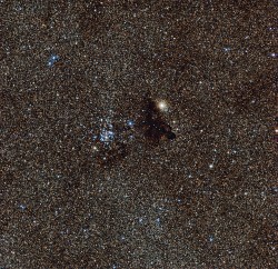This image from the Wide Field Imager on the MPG/ESO 2.2-metre telescope at ESO’s La Silla Observatory in Chile, shows the bright star cluster NGC 6520 and its neighbour, the strangely shaped dark cloud Barnard 86. This cosmic pair is set against millions of glowing stars from the brightest part of the Milky Way — a region so dense with stars that barely any dark sky is seen across the picture.