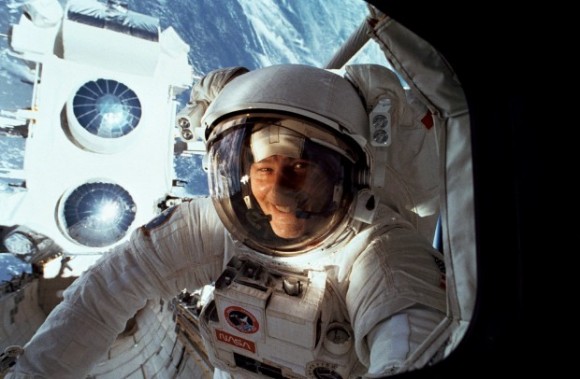 Jerry Ross peers into the orbiter crew cabin during the STS-37 mission, smiling because he manually extending the Gamma Ray Observatory’s antenna. Credit: NASA
