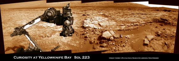 Curiosity's raised robotic arm and drill are staring at you in this new panoramic vista of Yellowknife Bay basin snapped on March 23, Sol 223 by the rover's navigation camera system. The raw images were stitched by Marco Di Lorenzo and Ken Kremer and colorized. Credit: NASA/JPL-Caltech/Marco Di Lorenzo/KenKremer (kenkremer.com)