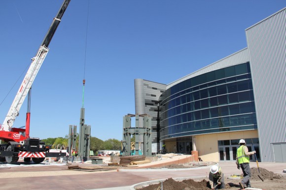 Workers install steel braces for outside display of twin shuttle Solid Rocket Boosters at new Space Shuttle Atlantis pavilions due to open in June 2013 the Kennedy Space Center Visitor Complex in Florida. Credit: Ken Kremer (kenkremer.com)