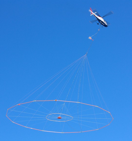 Koala helicopter towing Versatile Domain Electromagnetic Surveying equipment. (Credit: USGS).