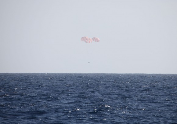 Dragon is slowed by three main parachutes prior to splashdown into the Pacific Ocean. Credit: SpaceX.
