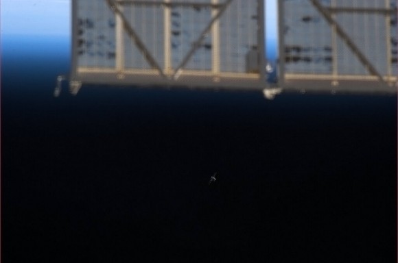 'Dragon comes into view - first sight this morning, sneaking up on us from behind the Progress solar array,' Tweeted Chris Hadfied. Credit: NASA/Chris Hadfield.