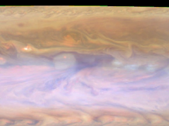 The dark hot spot in this false-color image from NASA's Cassini spacecraft is a window deep into Jupiter's atmosphere. All around it are layers of higher clouds, with colors indicating which layer of the atmosphere the clouds are in. Image credit: NASA/JPL-Caltech/SSI/GSFC