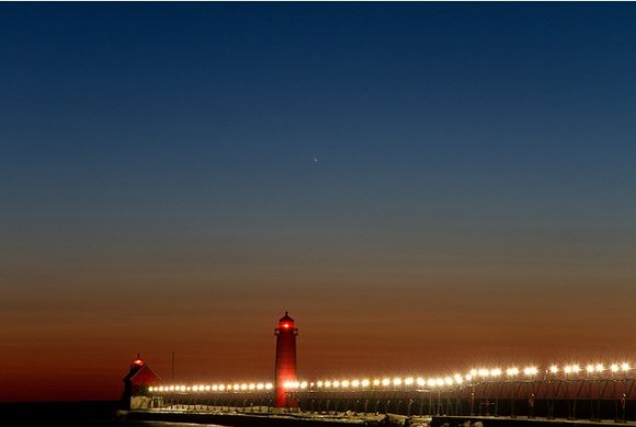 Comet C/2011 L4 (PANSTARRS) floats in the twilight sky over the lighthouses and pier at Grand Haven State Park in Grand Haven, Michigan on March 13, 2013. Credit and copyright: Kevin's Stuff on Flickr.