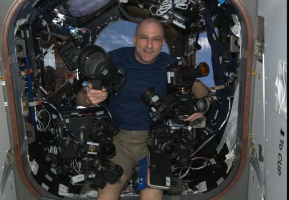 Astronaut Don Pettit with some of his cameras on board the International Space Station. Credit: NASA