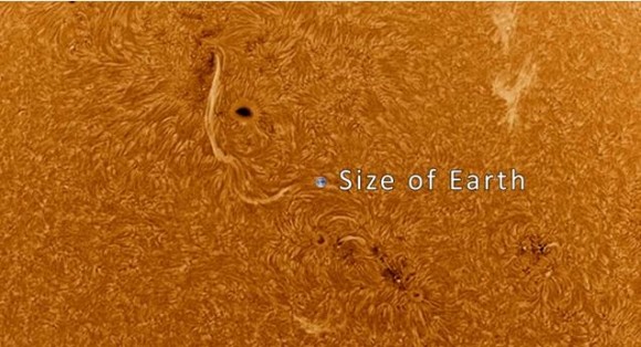 The size of Earth compared to sunspot AR1692 on March 15, 2013. Screenshot from the video by Göran Strand.