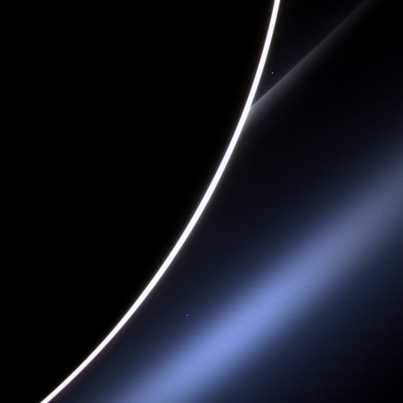 Venus appears just off the edge of the dark disc of Saturn, in the upper part of the image, directly above the white streak of Saturn's G ring. Credit: NASA/JPL-Caltech/Space Science Institute