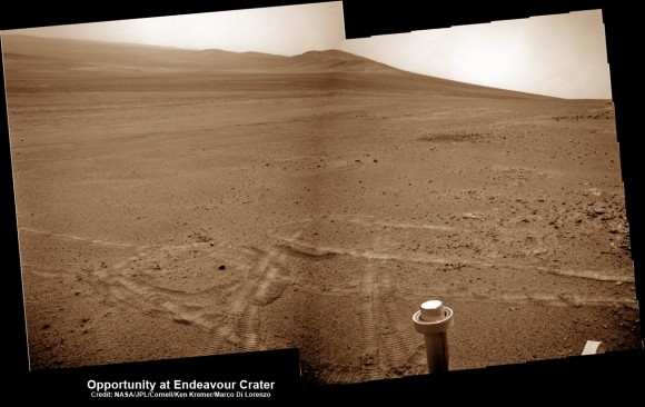 Opportunity pops a ‘wheelie’ on May 15, 2013 (Sol 3308) and then made history by driving further to the mountain ahead on the next day, May 16 (Sol 3309), to establish a new American driving record for a vehicle on another world.  This navcam mosaic shows the view forward to Opportunity’s future destinations of Solander Point and Cape Tribulation along the lengthy rim of huge Endeavour crater spanning 14 miles (22 km) in diameter.  Credit: NASA/JPL/Cornell/Kenneth Kremer/Marco Di Lorenzo.  