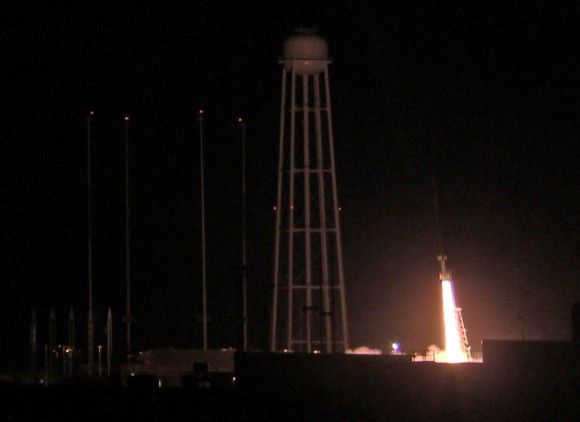 Ignition of NASA Black Brant XII suborbital rocket following night time launch at 11:05 p.m. EDT on June 5, 2013 from the NASA Wallops Flight Facility at the eastern Virginia shoreline. The launch pad sits in front of the Antares rocket Launch Complex 0A dominated by the huge water tower. The rocket carried the CIBER astronomy payload to an altitude of approximately 358 miles above the Atlantic Ocean to study when the first stars and galaxies formed in the universe and how brightly they burned their nuclear fuel. Credit: Ken Kremer- kenkremer.com