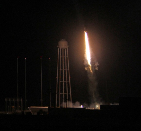 Night time blast off of 4 stage NASA Black Brant XII suborbital rocket at 11:05 p.m. EDT on June 5, 2013 from the NASA Wallops Flight Facility carrying the CIBER astronomy payload to study when the first stars and galaxies formed in the universe. The Black Brant soars above huge water tower at adjacent Antares rocket launch pad at NASA Wallops. Credit: Ken Kremer- kenkremer.com