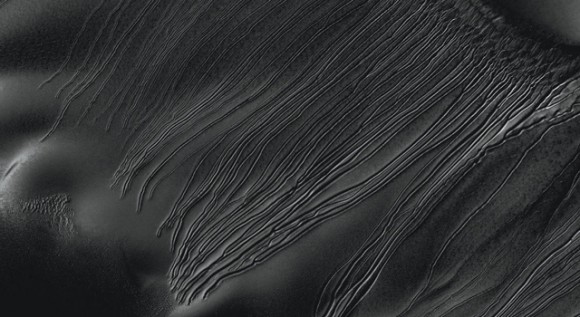 Several types of downhill flow features have been observed on Mars. This image from the High Resolution Imaging Science Experiment (HiRISE) camera on NASA's Mars Reconnaissance Orbiter is an example of a type called "linear gullies." Image credit: NASA/JPL-Caltech/Univ. of Arizona