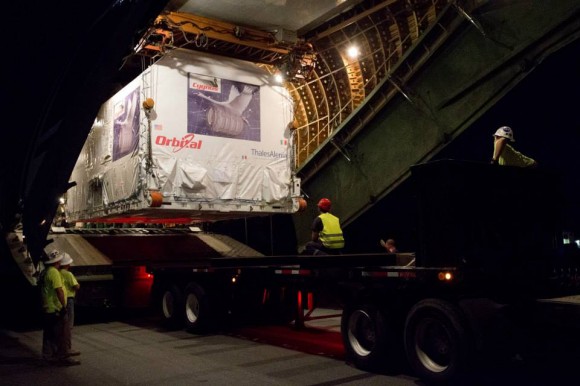 Cygnus stored inside shipping container is unloaded from Antonov An-124 aircraft after arrival at NASA Wallops, VA on July 17, 2013. Credit: NASA/Patrick Black