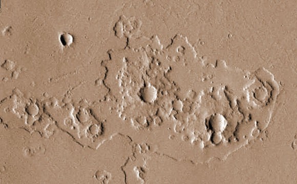 The eroded blankets of ejecta blasted out when these craters formed look like a series of interlocking gears.