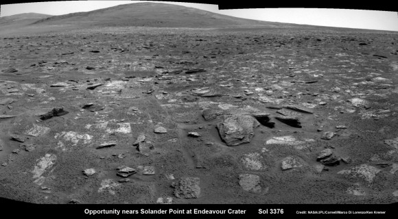 Opportunity rover moves closer to the foothills of Solander Point along the rim and vast expanse of Endeavour Crater. The rover investigated one of the large rocks here with her microscopic imager and X-Ray spectrometer. Soon she will start climbing up Solander - her 1st Martian Mountain ascent. This navcam panoramic mosaic was assembled from raw images taken on Sol 3376 (July 23, 2013). Credit: NASA/JPL/Cornell/Marco Di Lorenzo/Ken Kremer (kenkremer.com)