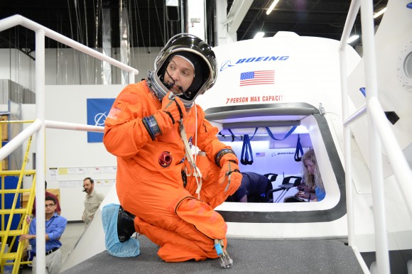 NASA astronaut Randy Bresnik prepares to enter the CST-100 spacecraft, which was built inside The Boeing Company's Houston Product Support Center. Credit:  NASA/Robert Markowitz