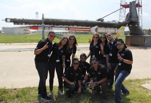 Rocket science university students from Puerto Rico pose for photo op with the Terrier-Improved Malemute sounding rocket that will launch their own developed RockSat-X science experiments to space on Aug. 13 at 6 a.m. from NASA Wallops Flight Facility, VA. Credit: Ken Kremer/kenkremer.com