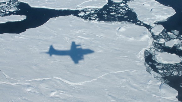 The NASA P-3B's shadow on sea ice off of southeast Greenland during an IceBridge survey on Apr. 9, 2013. Flying at a low altitude allows IceBridge researchers to gather detailed data. Credit: NASA / Jim Yungel