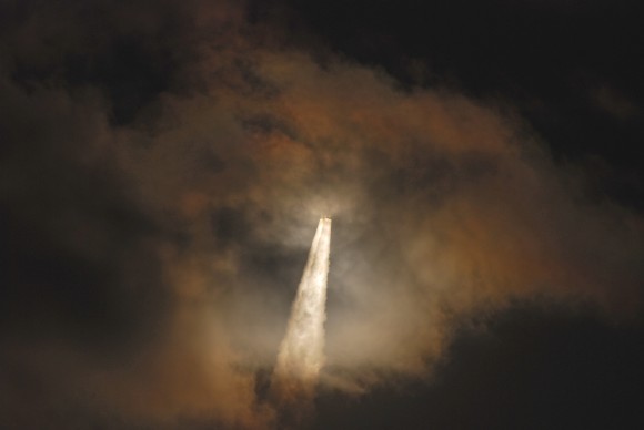 Through a cloud on its way to orbit, the Atlas 5 - 531 vehicle and it AEHF-3 payload dapple the clouds with light.... Credit and copyright: John O'Connor/nasatech.net.