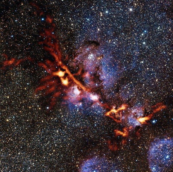 This image of the star formation region NGC 6334 is one of the first scientific images from the ArTeMiS instrument on APEX. The picture shows the glow detected at a wavelength of 0.35 millimetres coming from dense clouds of interstellar dust grains. The new observations from ArTeMiS show up in orange and have been superimposed on a view of the same region taken in near-infrared light by ESO’s VISTA telescope at Paranal. Credit: ArTeMiS team/Ph. André, M. Hennemann, V. Revéret et al./ESO/J. Emerson/VISTA Acknowledgment: Cambridge Astronomical Survey Unit