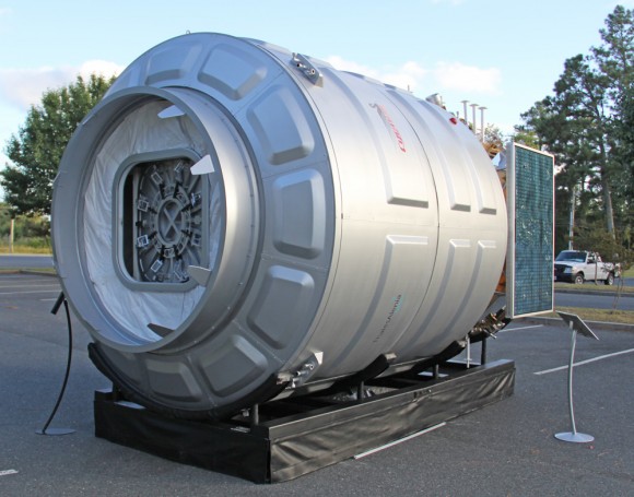 Front view showing docking mechanism and hatch of Cygnus module in this full scale, high fidelity mockup of the Orbital Sciences/Thales Alenia spacecraft gives a feel for it being similar in size to a small room. Credit: Ken Kremer (kenkremer.com)