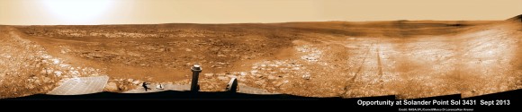 Opportunity starts scaling Solander Point - her 1st mountain climbing goal. See the tilted terrain and rover tracks in this panoramic view from Solander Point peering across the vast expanse of huge Endeavour Crater. Opportunity will ascend the mountain looking for clues indicative of a Martian habitable environment. This navcam camera mosaic was assembled from raw images taken on Sol 3431 (Sept.18, 2013). Credit: NASA/JPL/Cornell/Marco Di Lorenzo/Ken Kremer (kenkremer.com).