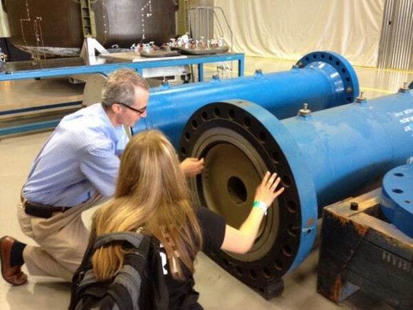 Abigail Harrison with subscale test rocket motors during a visit to the Marshall Space Flight Center in Huntsville, AL. Credit: Abigail Harrison