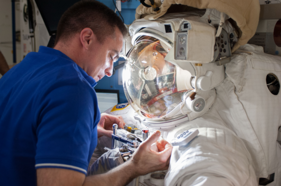 Astronaut Chris Cassidy works with Luca Parmitano's spacesuit, which had a water leak on July 16, 2013. Credit: NASA