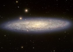 NGC 253, aka the Sculptor Galaxy, is also blowing out gas but as the result of star formation (Image: T.A. Rector/University of Alaska Anchorage, T. Abbott and NOAO/AURA/NSF)