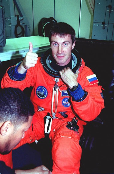 Sergei Krikalev gives a thumbs up during suit check before the launch of STS-88 in 1998. Credit: NASA.