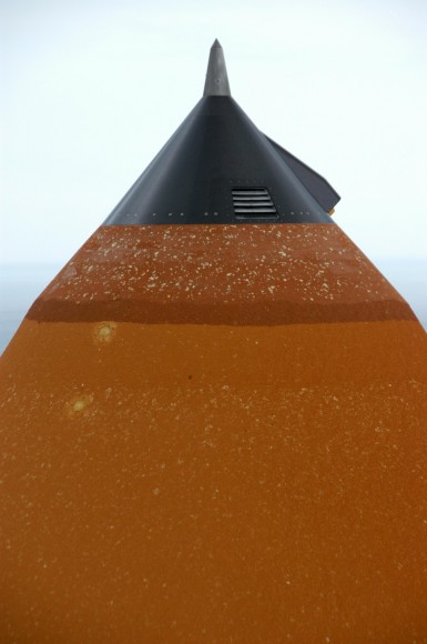 Hail damage is visible on the external tank attached to Space Shuttle Atlantis on the launchpad during a strong thunderstorm that passed through Kennedy Space Center on Feb. 26, 2007. Credit: NASA/KSC.
