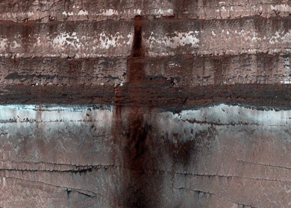 Loose soil, dust and rock stains an icy cliffside on Mars (NASA/JPL/University of Arizona)