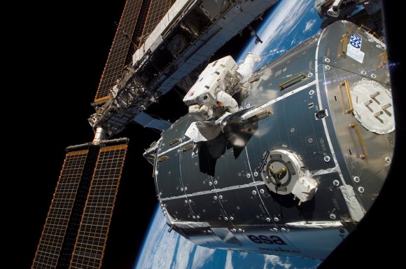 European Space Agency astronaut Hans Schlegel works on installing the ESA Columbus laboratory in 2008. The ten racks on board Columbus can be worked on by astronauts or controlled remotely from a center in Germany. NASA is trying to position the station as an orbiting laboratory that can perform experiments that are impossible on Earth, but astronauts must balance science work with maintenance tasks aboard the station. Credit: NASA