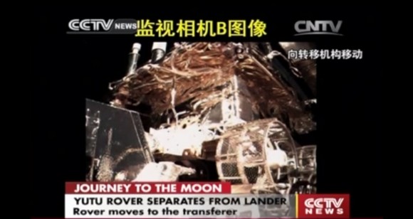 Yutu moves towards drive off ramp still atop the Chang’e-3 lander, shown in this screen shot from early Dec. 15, 2013. Credit: CCTV