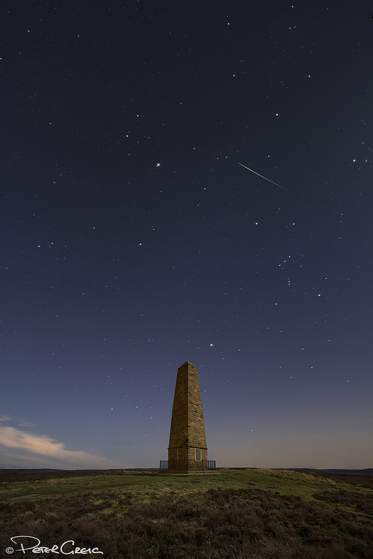 A Geminid meteor on Dec. 14, 2013 over the Captain Cook Monument in North Yorkshire, UK. Credit and copyright: Peter Greig. 
