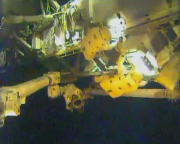 NASA astronaut Rick Mastracchio (right) pulls an 800-pound ammonia pump module out of its spot on the space station Dec. 21, 2013. At left is fellow NASA astronaut and Expedition 38 member Mike Hopkins. Credit: NASA TV