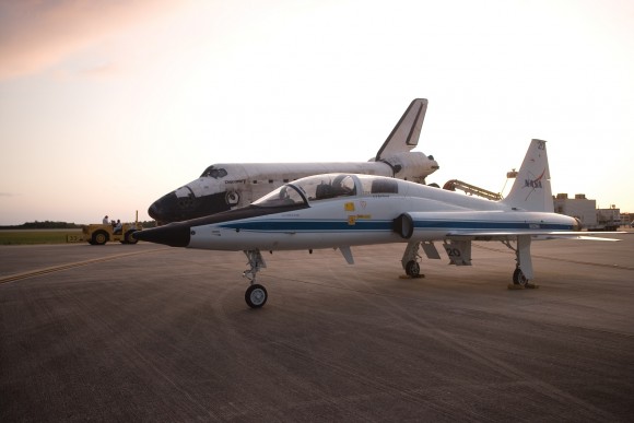 A T-38 plane parked in front of space shuttle Discovery in this undated photo taken by NASA astronaut Story Musgrave, who flew six times in space in the 1980s and 1990s.