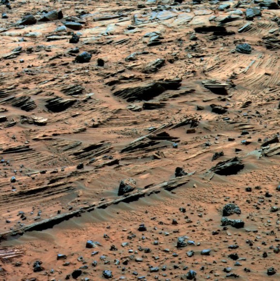 Spirit examined spectacular layered rocks exposed at "Home Plate." The rover has drove around the northern and eastern edges of Home Plate. Before departing, Spirit took this image showing some of the most complex layering patterns seen so far at this location. Scientists suspect that the rocks at Home Plate were formed in the aftermath of a volcanic explosion or impact event, and they are investigating the possibility that wind may also have played a role in redistributing materials after such an event. Credit: NASA/JPL-Caltech/Cornell